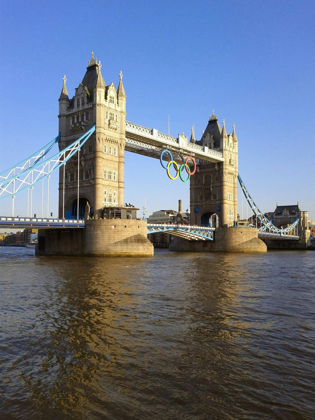 The River Thames, with the famous Tower Bridge and a sign for the 2012 Olympics visible.